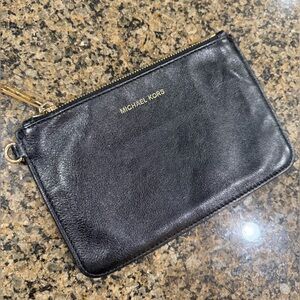 Authentic Michael Kors leather zip wristlet in black with golden hardware